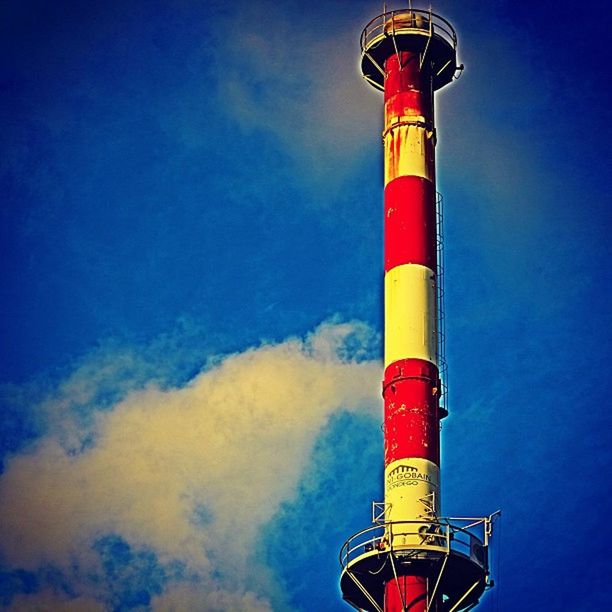 low angle view, red, blue, guidance, lighthouse, sky, protection, safety, multi colored, direction, no people, outdoors, pole, security, yellow, tower, day, built structure, striped, metal