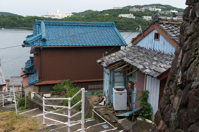 High angle view of buildings against blue sky