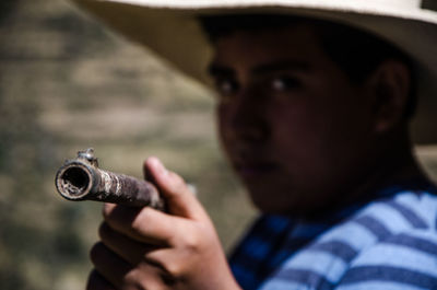 Close-up portrait of man holding camera