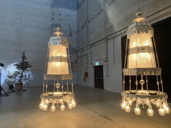 Illuminated lanterns hanging in building at night