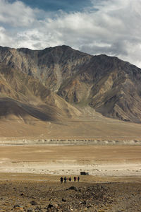 Scenic view of mountains against cloudy sky