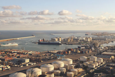 High angle view of cityscape by sea against sky