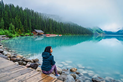 Rear view of woman looking at lake