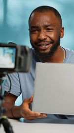 Portrait of man vlogging at home