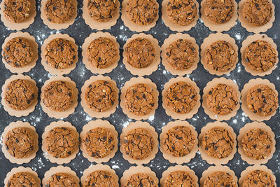 Full frame shot of cookies arranged on black table