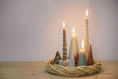 Close-up of illuminated candles on table