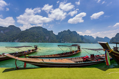 Scenic view of sea and mountains against sky