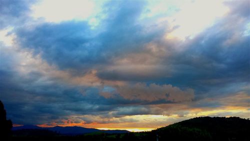 Scenic view of mountains against cloudy sky