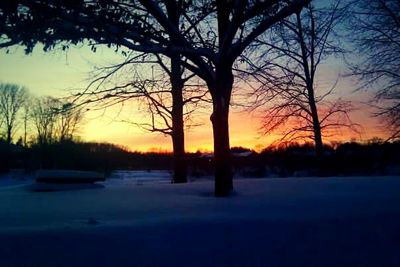 Scenic view of snow covered landscape at sunset