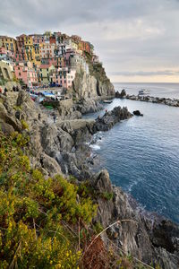 View of houses on rocky coast