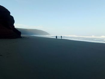 Scenic view of beach against clear sky