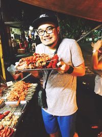 Portrait of young man eating food