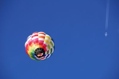 Low angle view of hot air balloon against blue sky