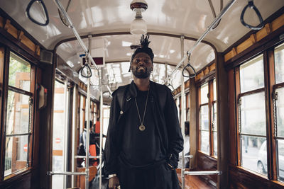 Young man standing in bus