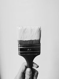 Close-up of person hand against white background