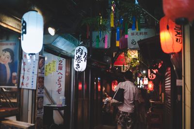 People standing in illuminated store at night