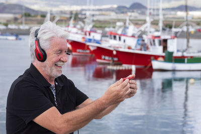 Man looking at boat on shore