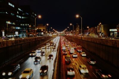 Vehicles on road in city at night