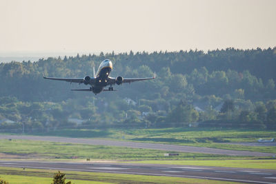 Airplane taking off against sky