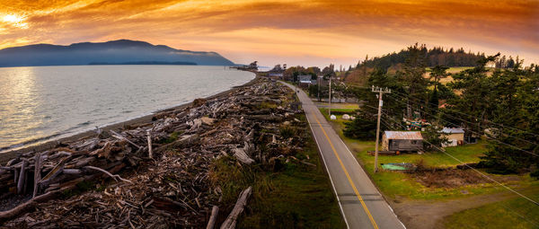 High angle view of road by sea against sky during sunset