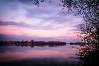 Scenic view of lake against sky at sunset