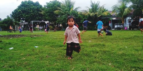 Full length portrait of girl on field