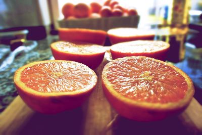 Close-up of halved oranges on cutting board