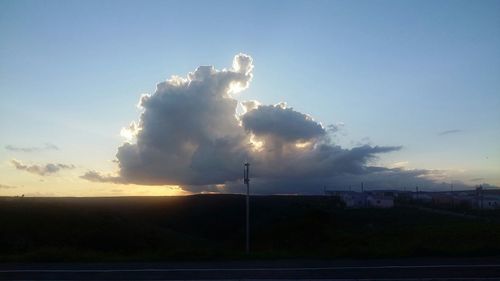 Scenic view of field against sky at sunset