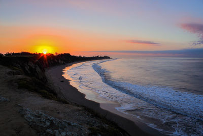 Scenic view of beach against sky during sunset