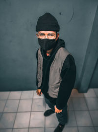 Full length of boy standing against wall