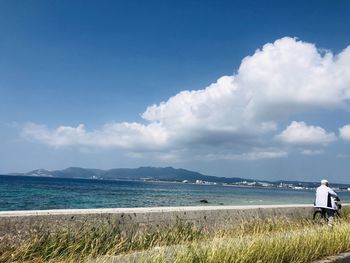 Rear view of sea against sky