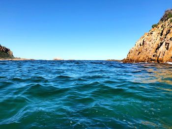 Scenic view of sea against clear blue sky