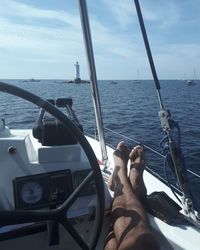 Low section of man on boat sailing in sea