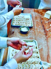 High angle view of people working on table