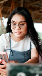 Portrait of woman using mobile phone