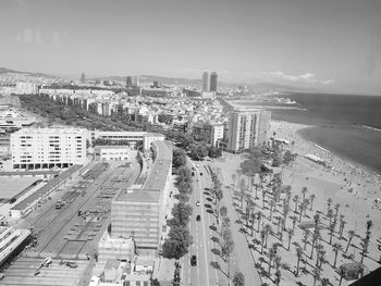 High angle view of buildings by sea against sky