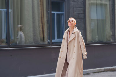 Woman standing against window