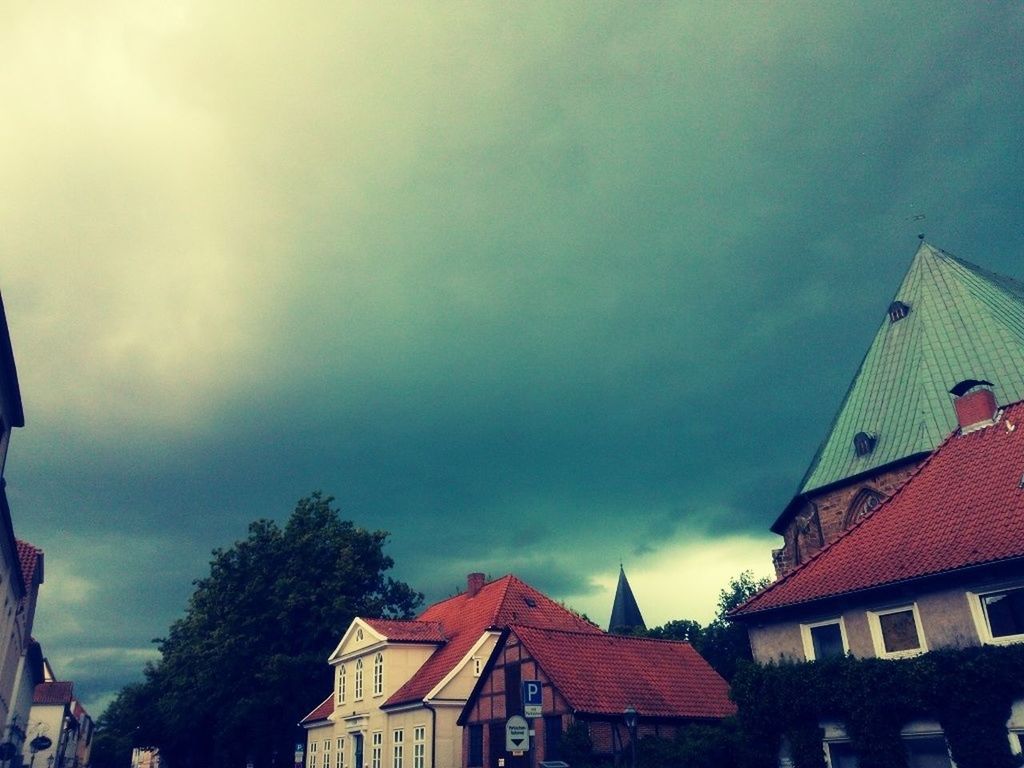 building exterior, architecture, built structure, sky, low angle view, house, roof, residential structure, cloud - sky, high section, residential building, cloudy, cloud, outdoors, building, weather, day, overcast, no people, town