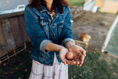 Fresh organic eggs in female hands on a private farm.