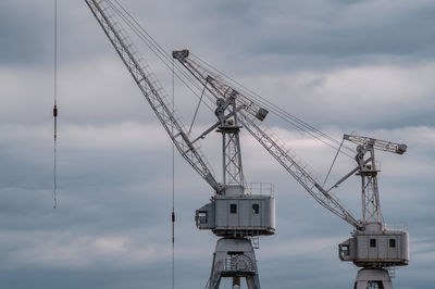 Low angle view of crane against sky