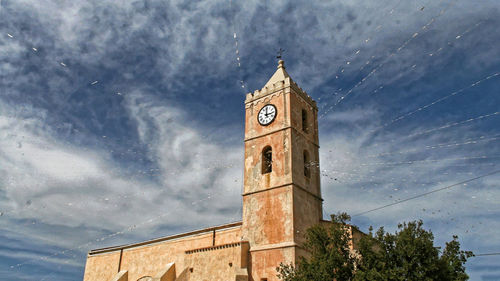 Low angle view of clock tower against sky