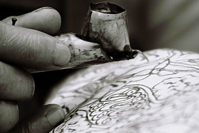 Close-up of hand holding cigarette