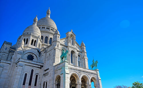 Low angle view of a building against blue sky