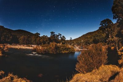 Scenic view of lake against sky at night