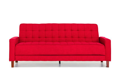 Red chair on sofa against white background