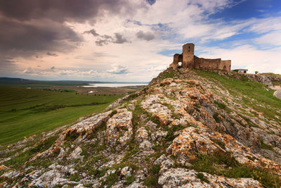 Castle on mountain against sky