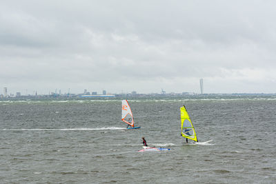 Sailboat in sea against sky