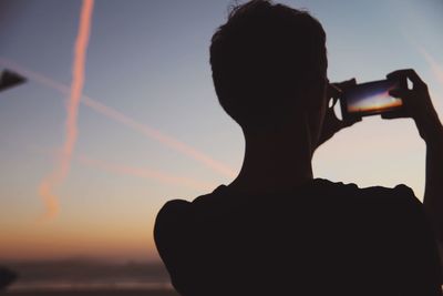 Silhouette of woman at sunset