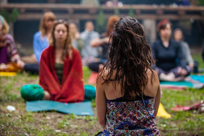 Rear view of women sitting outdoors