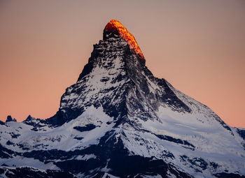 Scenic view of matterhorn mountain against clear sky during sunset